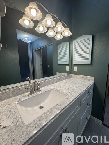 A bathroom with a sink and a mirror.