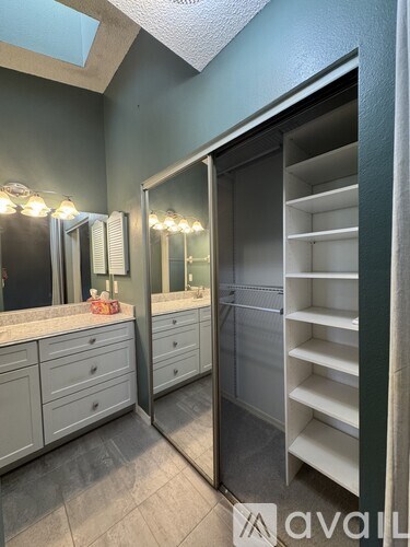A bathroom with a large mirror and a walk-in shower.
