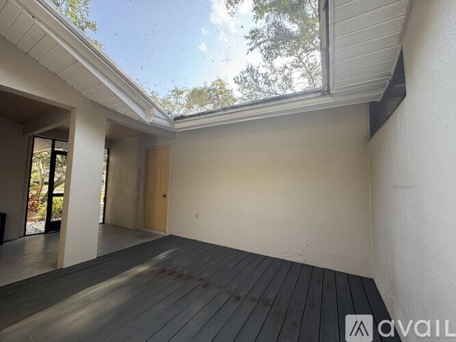 A room with wooden flooring and a skylight.