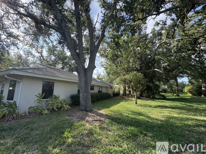 A house with a tree in front of it is for sale.