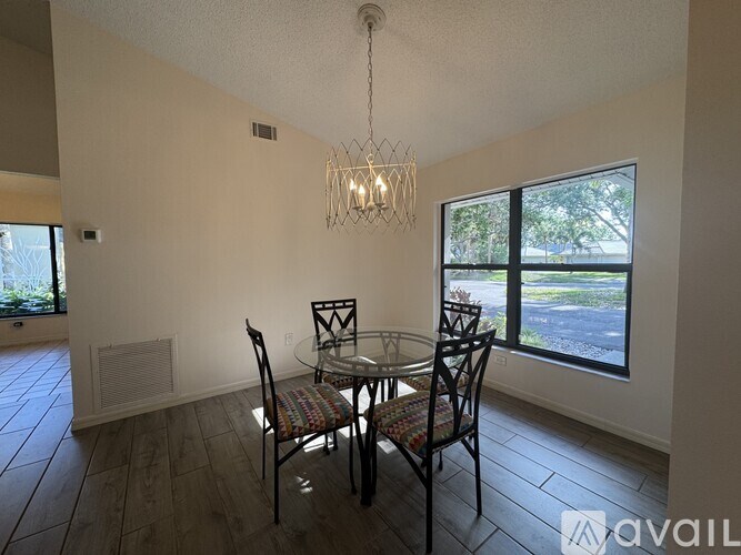 A dining room with a table set for four.