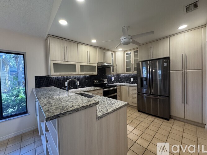 A kitchen with granite countertops and stainless steel appliances.