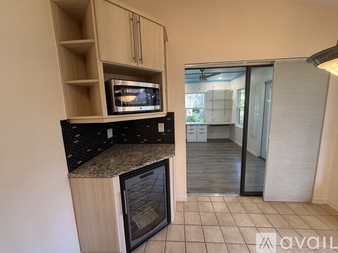 A kitchen with a microwave and oven built into the cabinetry.