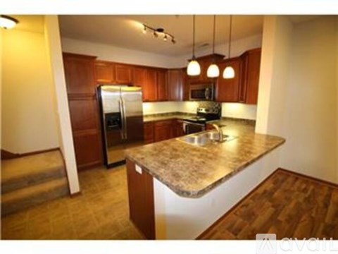 A kitchen with wooden cabinets and a granite countertop.