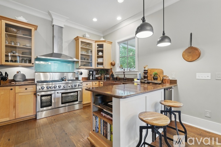 A modern kitchen with wooden cabinets and stainless steel appliances.