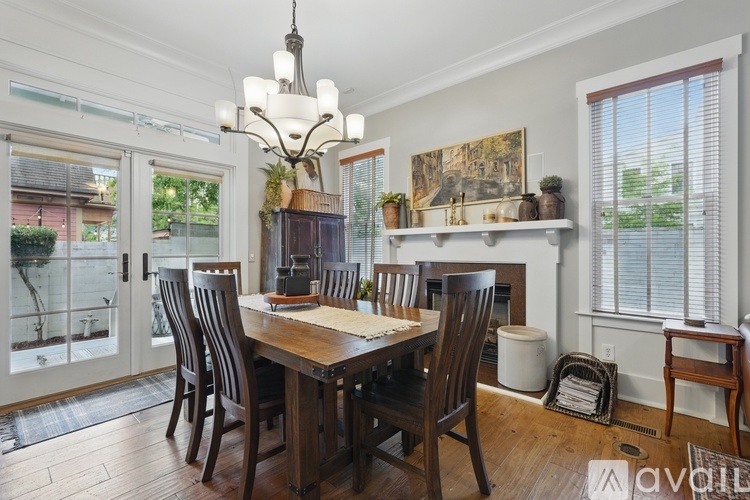 A dining room with a wooden table and chairs.