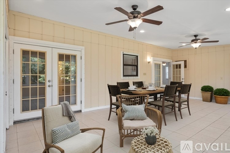 A dining room with a table set for four.