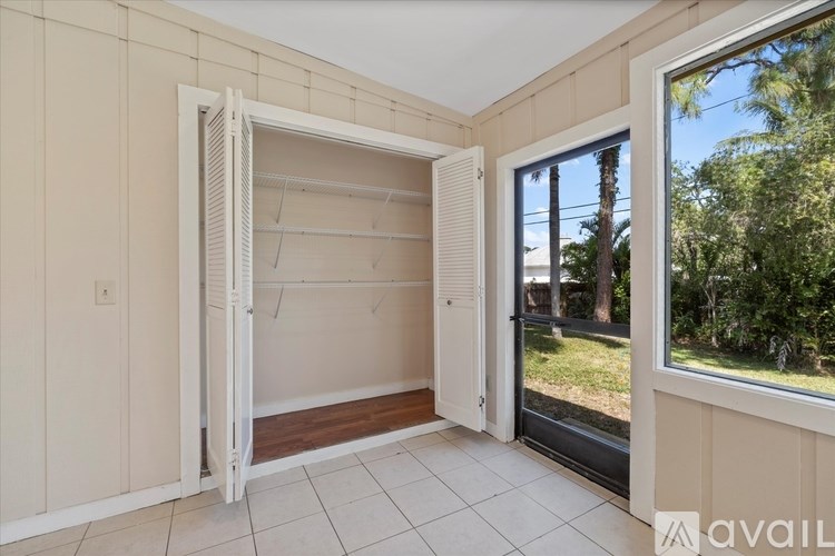 A room with a sliding door open to a balcony.
