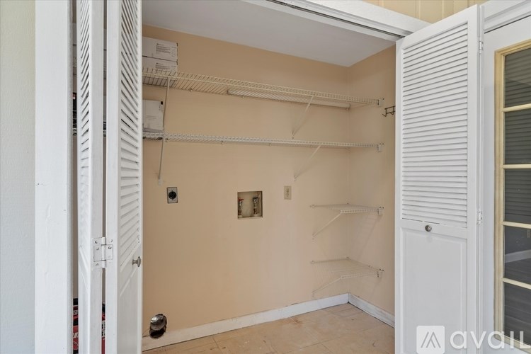 A room with a white door and a wall with a switch.