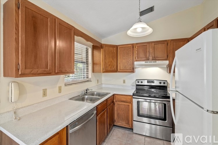 A kitchen with wooden cabinets and stainless steel appliances.