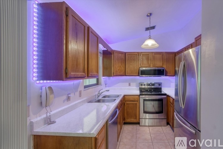 A kitchen with wooden cabinets and a white refrigerator.