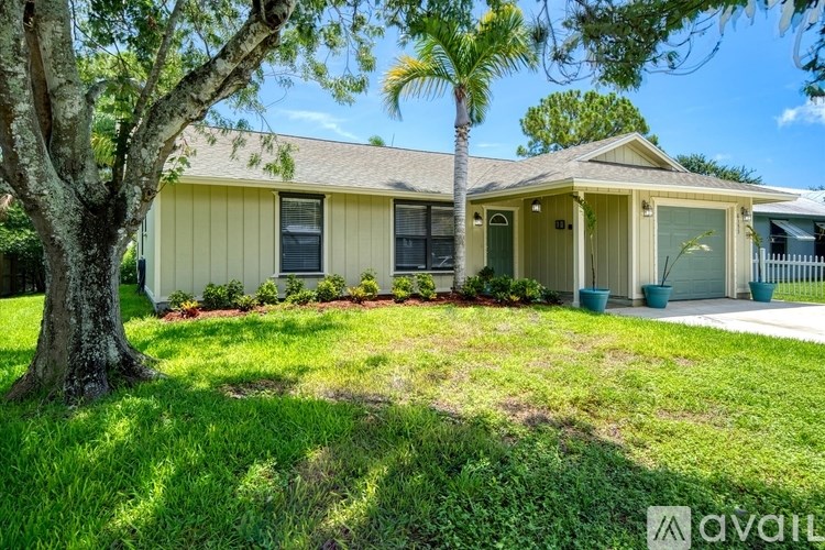 A house with a tree in front of it.