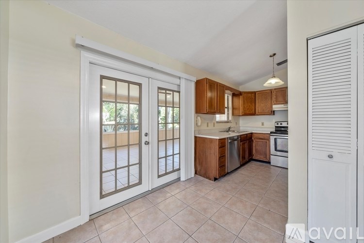 A kitchen with white walls and a tiled floor.