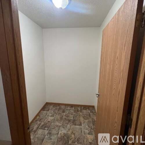 A room with a tiled floor and a wooden door.