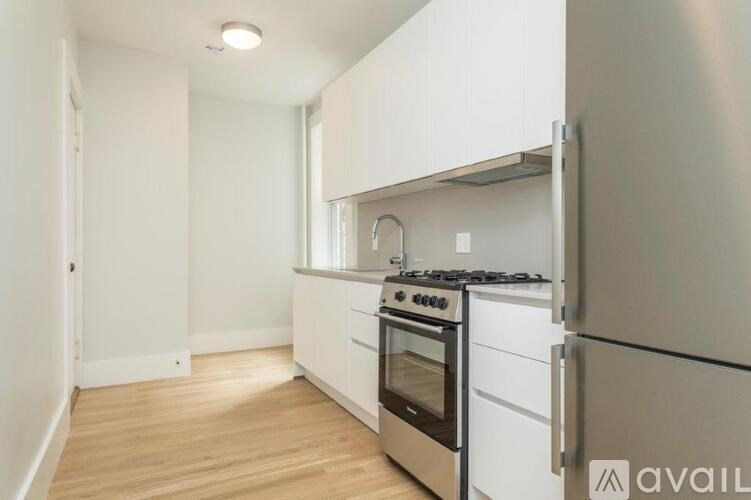 A kitchen with a stove and a refrigerator.