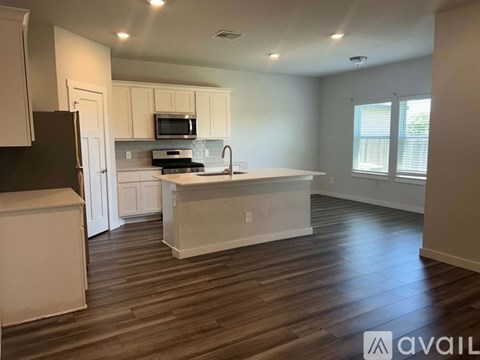 A two-story house with a garage is for sale.
