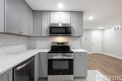 A modern kitchen with a stainless steel oven and microwave above the stove.