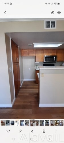 A kitchen with wooden cabinets and a white countertop.