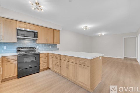 A kitchen with wooden cabinets and a black oven.