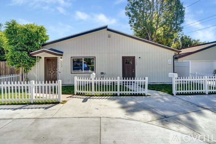 A kitchen with wooden cabinets and a black stove top oven.