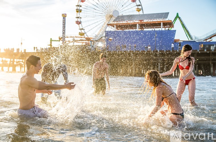 People are playing in the water at a beach.