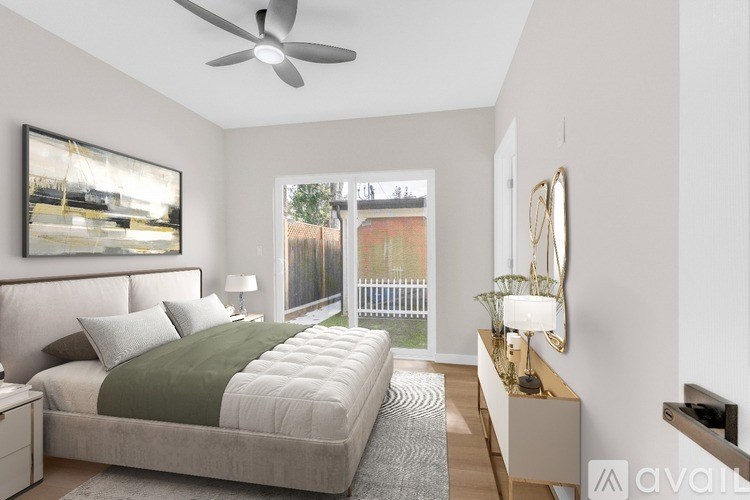 A bedroom with a bed, nightstand, and a painting on the wall.