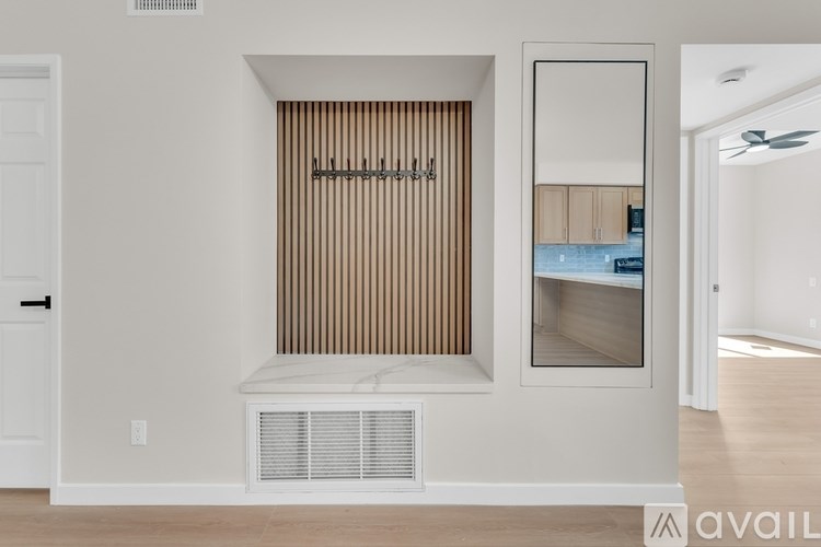 A bathroom with a toilet, sink, mirror, and shower.