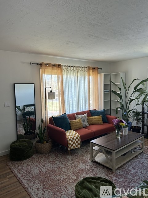 A living room with a red couch and a coffee table.