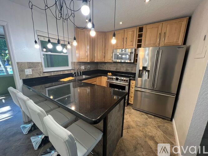A modern kitchen with a glass island and stainless steel appliances.