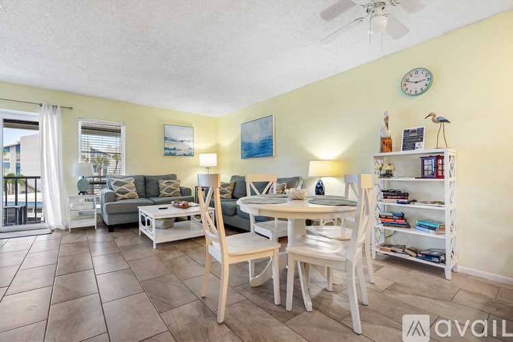A bathroom with a white counter top and white cabinets.