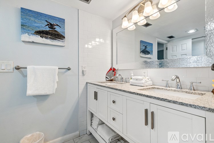 A bathroom with a white towel hanging on a towel rack.