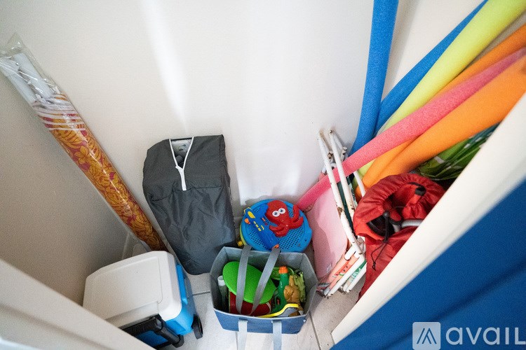 A bag of clothes and other items are packed into a suitcase.