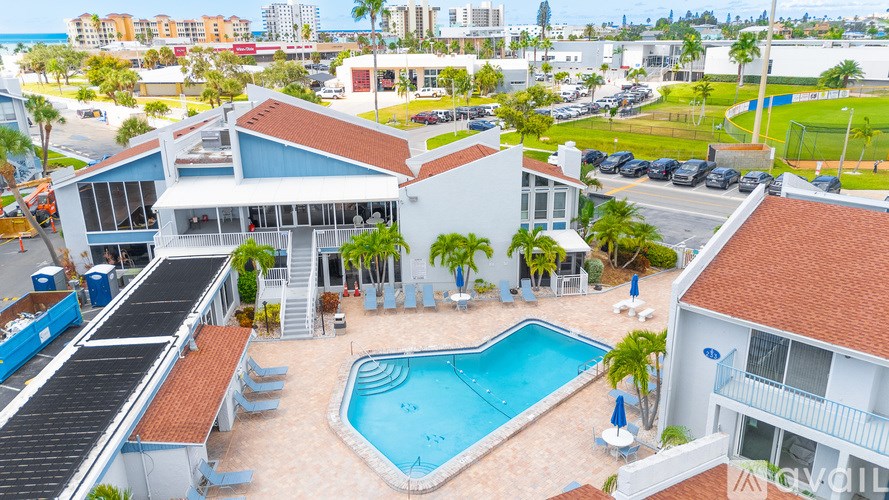 A large white house with a pool in the middle of it.