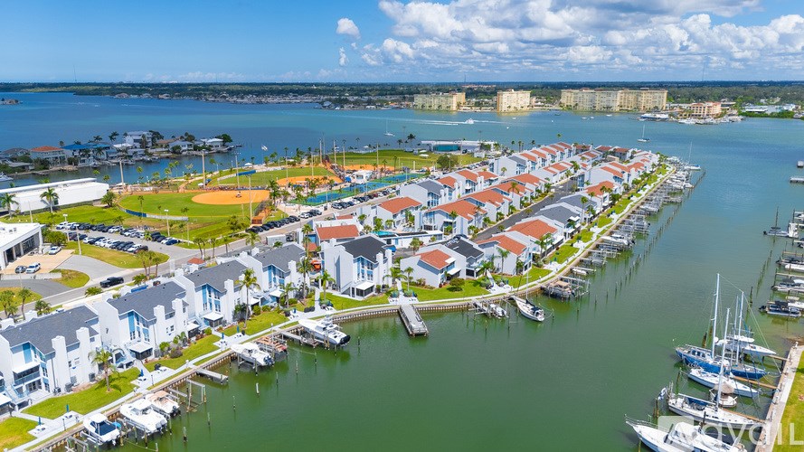 A marina with boats and houses.