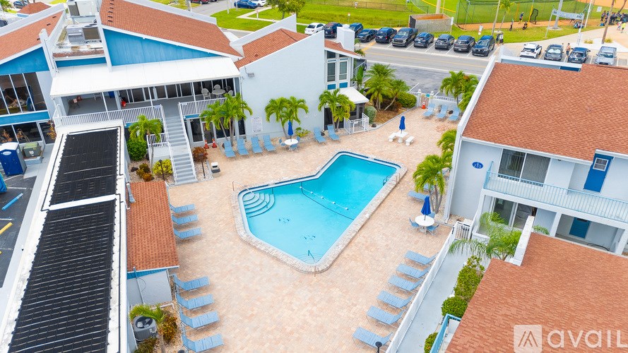 A bird's eye view of a resort with a swimming pool and sun loungers.