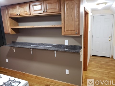 A kitchen with wooden cabinets and a countertop.