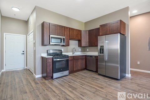 A kitchen with wooden cabinets and stainless steel appliances.