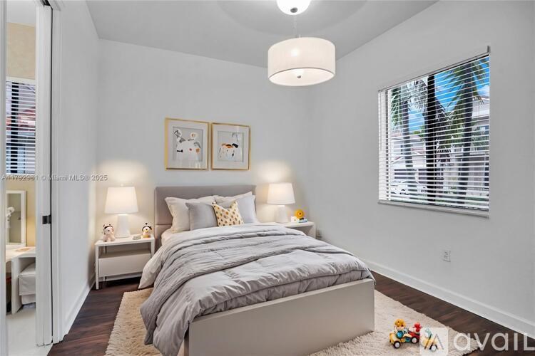 A bedroom with a large bed and two lamps.