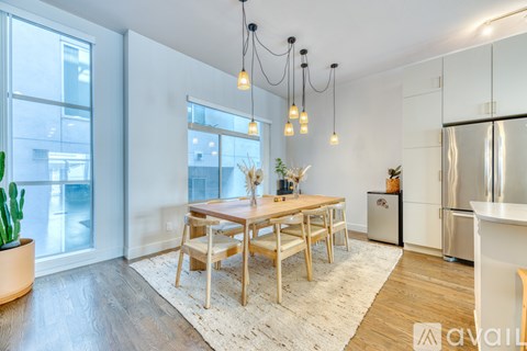 A modern kitchen with a dining table and chairs.