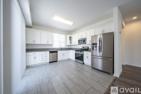 A kitchen with white cabinets and stainless steel appliances.