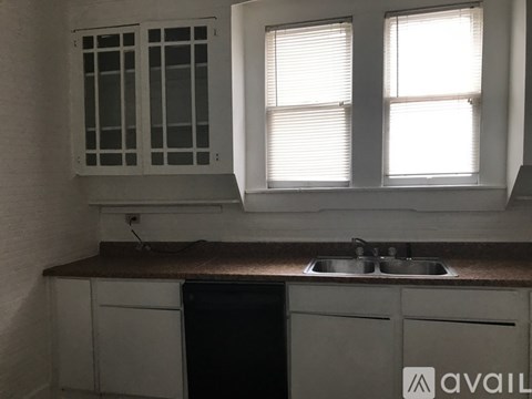 A kitchen with a sink and a window.