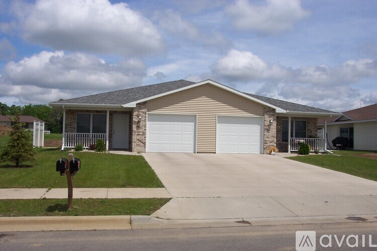 A house with a beige garage door is for sale.