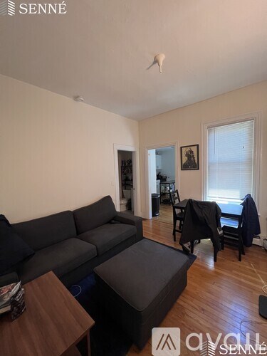 A living room with a grey couch and a wooden table.