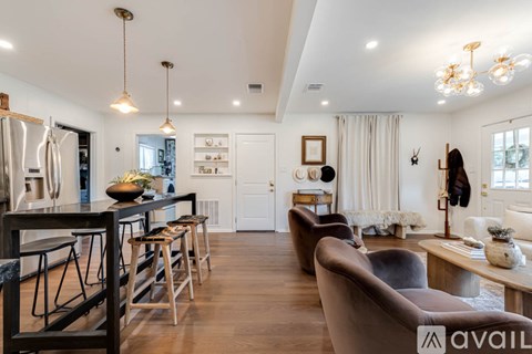 A modern kitchen with a bar area and a dining table.