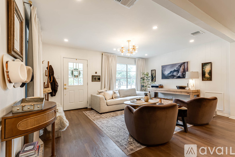 A living room with a brown chair and a wooden table.