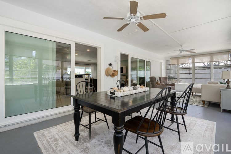 A dining room with a table and chairs.