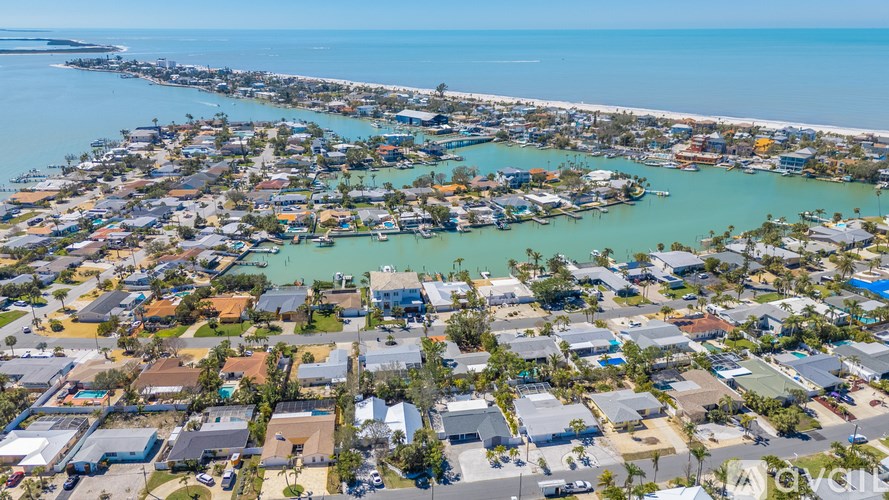 A coastal town with a long pier extending into the water.