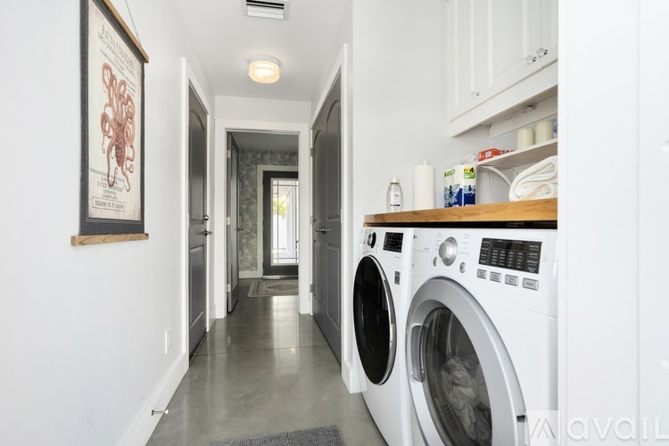 A laundry room with a washer and dryer in it.