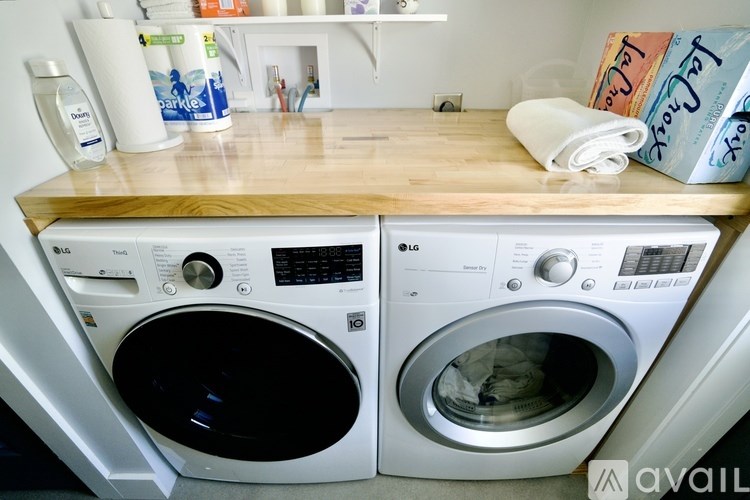 Two front loading washing machines in a laundry room.