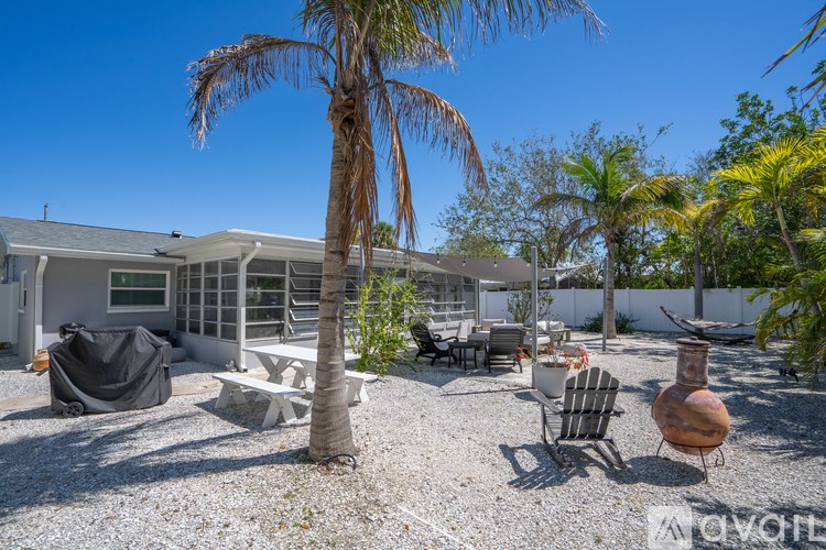 A house with a palm tree in front of it.